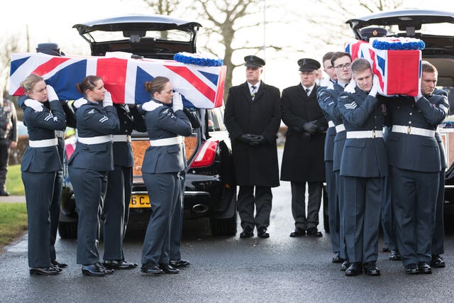 Coffins are carried into the crematorium during the funeral (Aaron Chown/PA Wire)
