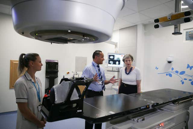 Theresa May is shown the advanced radiotherapy system during her visit to Addenbrooke's (Daniel Leal-Olivas/PA)