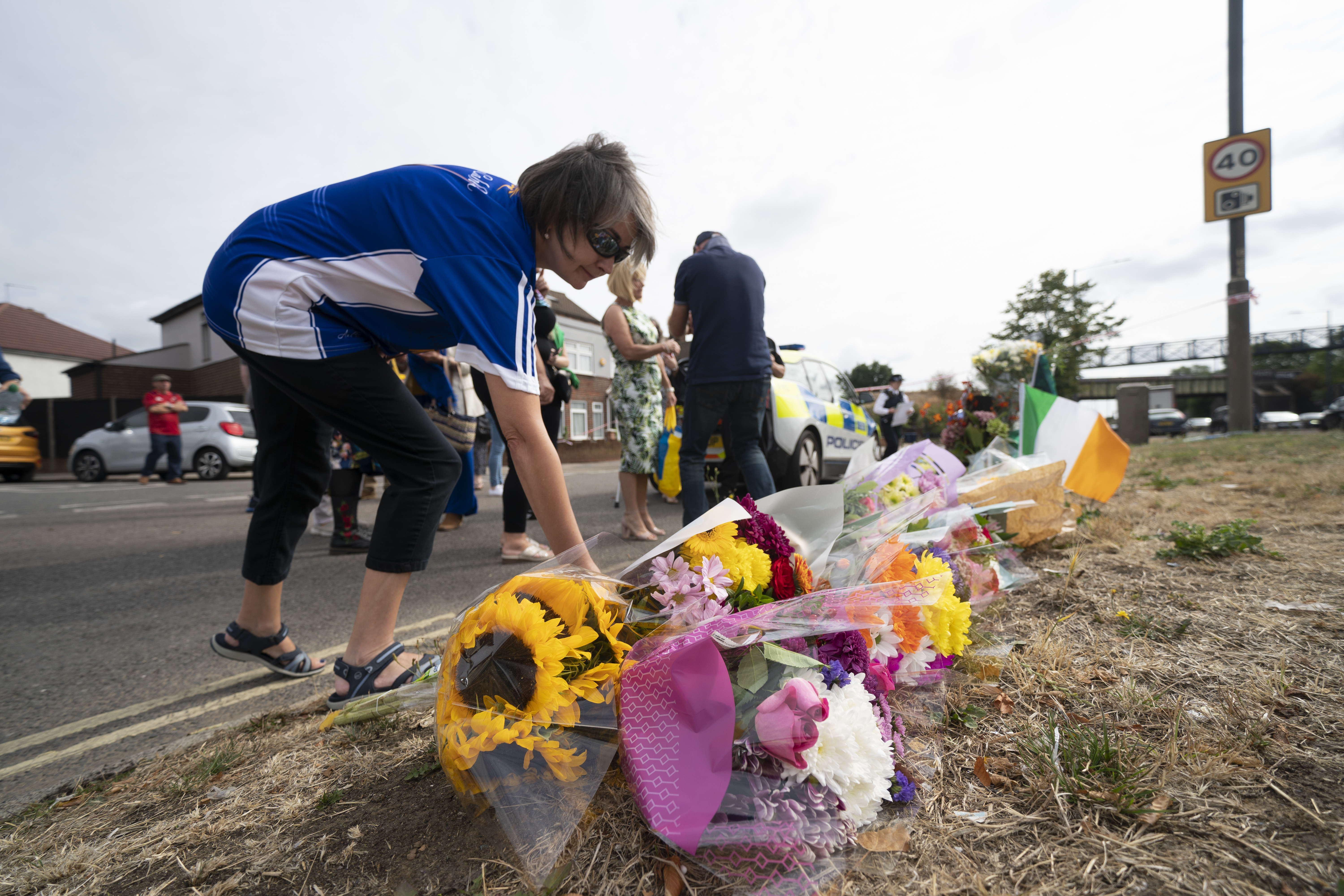 A woman lays flowers in memory of Mr O'Halloran