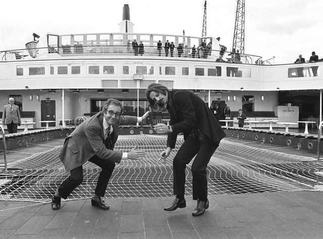 Peter Sellers and Ringo Starr getting ready for some deck games on board the QE2 at Southampton (PA)