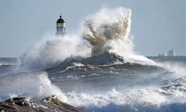 Waves crash against the pier wall at Seaham Lighthouse on the County Durham coast