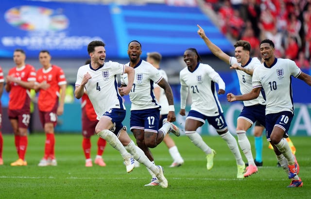 England players rush to celebrate their penalty shootout win over Switzerland