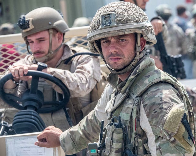 Armed forces personnel trained for battle are instead holding babies and co-ordinating crowds in Afghanistan, the Defence Secretary said