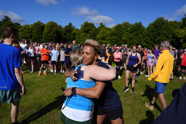 Dame Kelly Holmes hugs a runner at Bushy Park