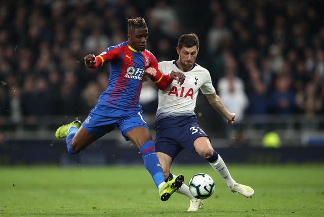 Wilfried Zaha, left, and Ben Davies battle for the ball