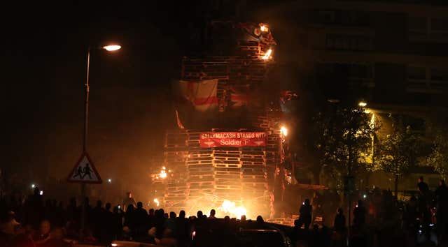 Crowds watch as the bonfire is lit