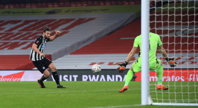 Andy Carroll, left, is denied by Bernd Leno