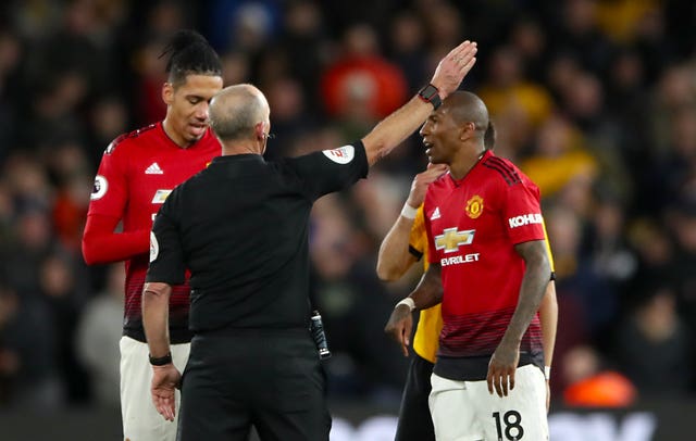 Mike Dean gives Manchester United's Ashley Young, right, his marching orders