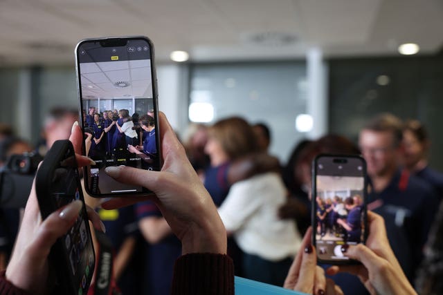 People using smart phones to take pictures of Rachel Reeves hugging a nurse at a post-Budget press conference