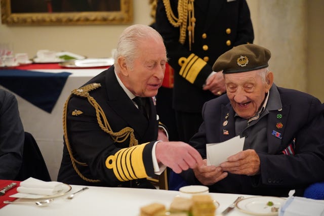 The King chatting to Second World War veteran Joe Mines at a tea party in Buckingham Palace