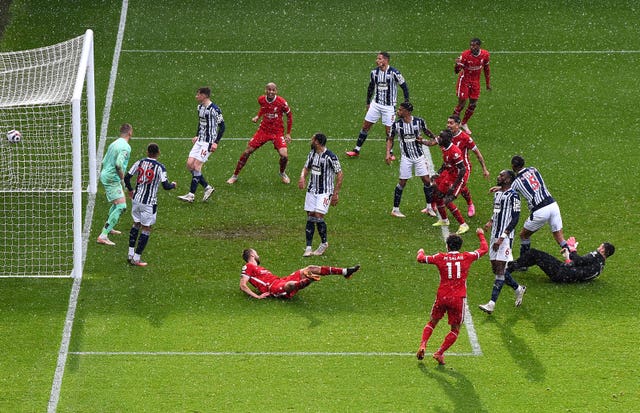 Liverpool goalkeeper Alisson, right, headed a stoppage-time winner at West Brom