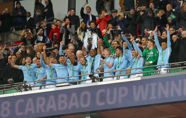 Manchester City’s Vincent Kompany celebrates with the trophy alongside team-mates after the final whistle during the Carabao Cup Final