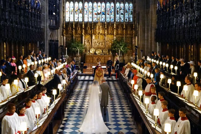 Charles escorts Meghan up the aisle of St George’s Chapel on her wedding day