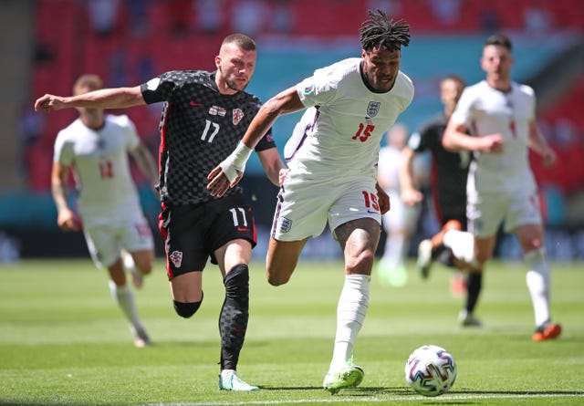 Tyrone Mings shields the ball from Croatia’s Ante Rebic, left