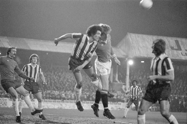 Black and white image of Gordon McQueen in action for Manchester United against Colchester United