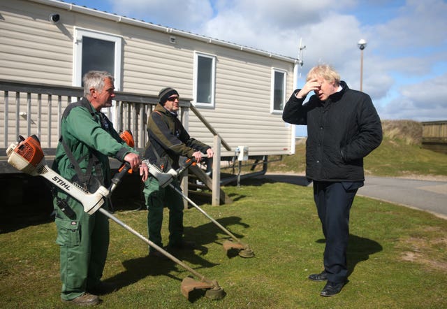 Prime Minister Boris Johnson speaks with staff during a visit to Haven Perran Sands Holiday Park in Perranporth, Cornwall