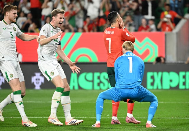 Caoimhin Kelleher celebrates saving Cristiano Ronaldo's penalty