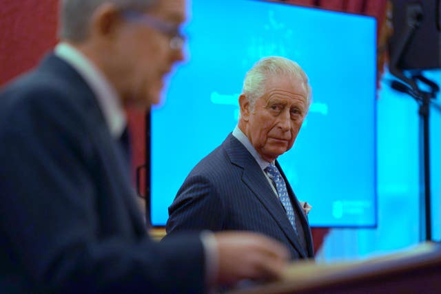 The Prince of Wales listens as Lord Browne speaks