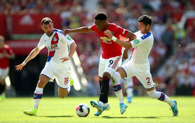 Anthony Martial battles for the ball with two visiting defenders 