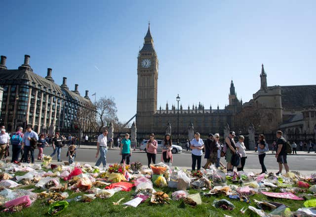 Floral tributes in Parliament Square outside the Palace of Westminster following the terror attack
