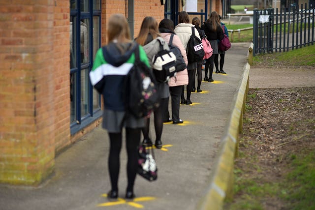 Pupils queuing to take a lateral flow test at Archway School in Stroud in Gloucestershire (Ben Birchall/PA)
