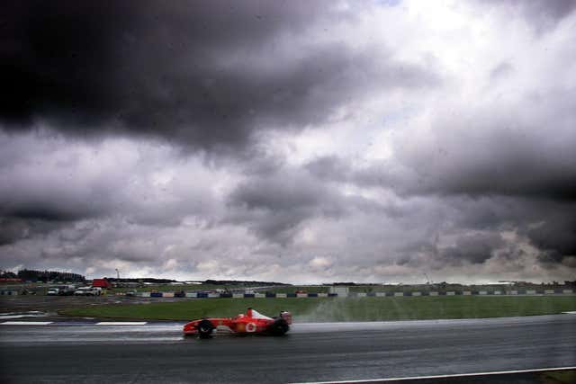 Rubens Barrichello blasts around Club Corner in his Ferrari during the first official practice in 2002. The Ferrari-driving Brazilian won the race a year later