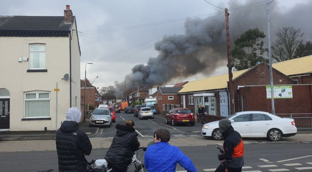 Smoke rises from a fire at a three-storey warehouse in Holland Street, Denton, Manchester
