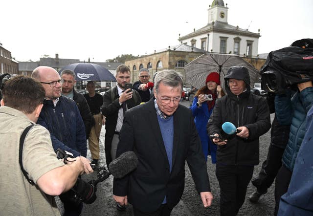 Breandan Mac Cionnaith walking among a group of people