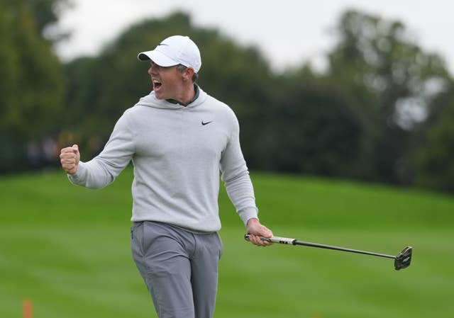 Rory McIlroy celebrates after his eagle putt on the 18th to force a play-off