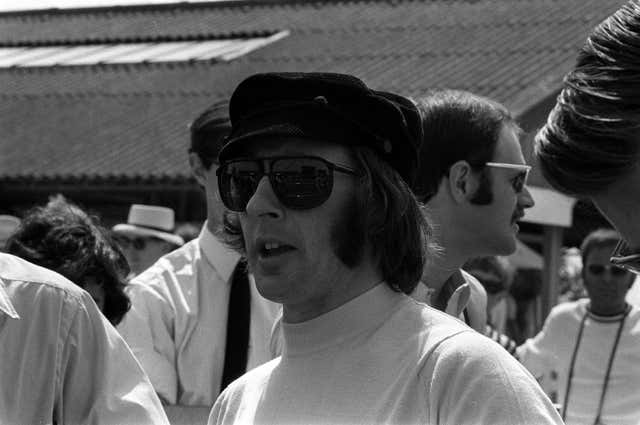 Sir Jackie Stewart, a two-time Silverstone champion, relaxes in the paddock in 1969. He would go on to win the race and the world championship that year