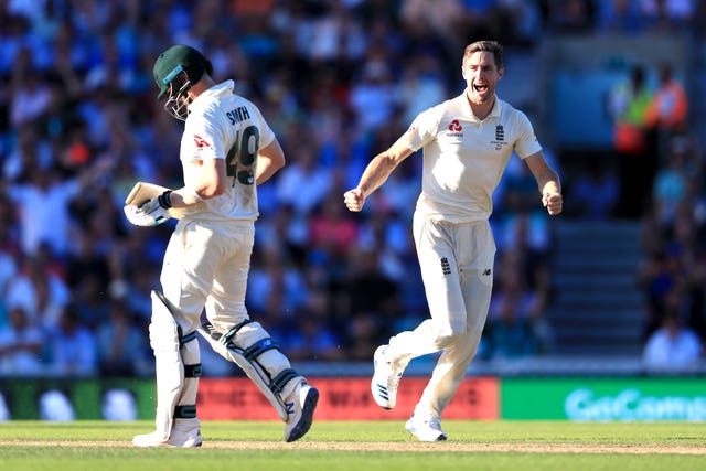 Chris Woakes, right, celebrates the wicket of Steve Smith, left