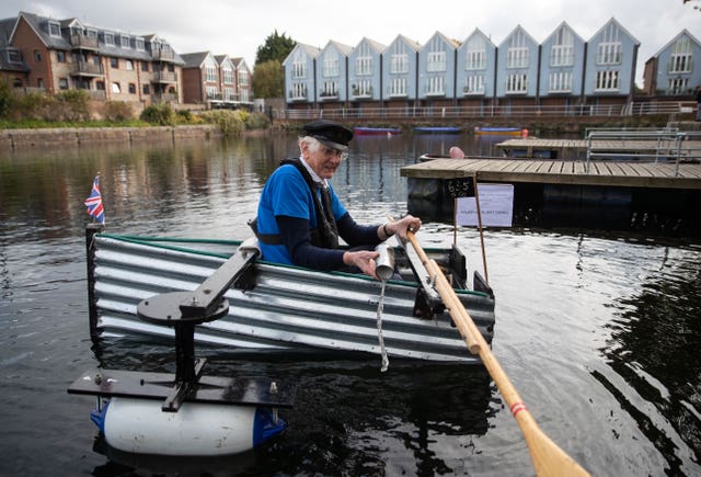 Major Mick bails out water during his journey