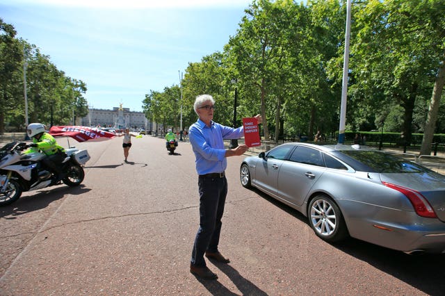 Greenpeace UK executive director, John Sauven attempts to hand Boris Johnson a 134 point Climate Emergency manifesto (Greenpeace/PA)