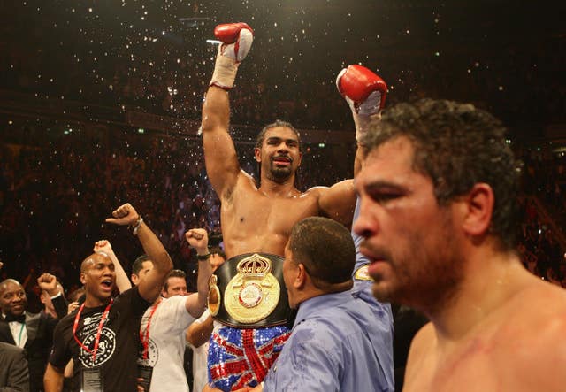 David Haye celebrates after the fight as John Ruiz, front right, leaves the ring