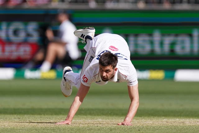Mark Wood falls over while bowling in England's first Ashes Test in Perth.