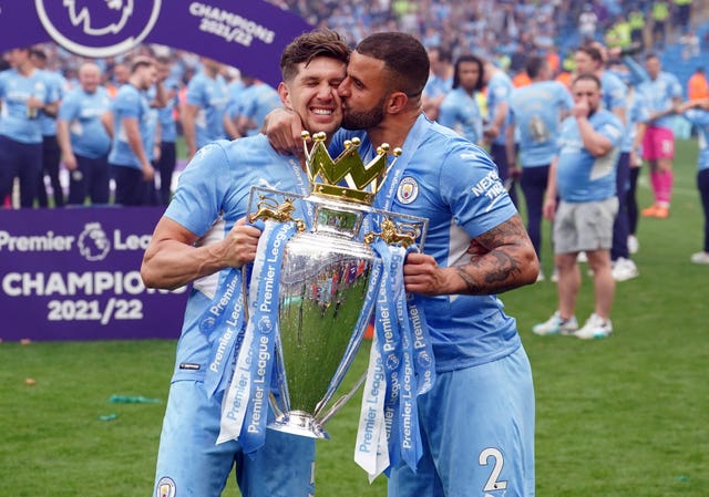 Kyle Walker (right) celebrates witj John Stones and the Premier League trophy