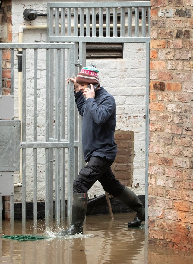 A man navigates flood water in York