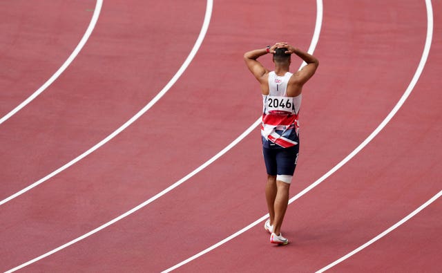 Adam Gemili walks the track after pulling up injured during the men's 200m heats