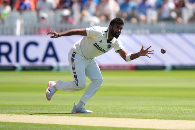 India's Jasprit Bumrah fields off his own bowling.