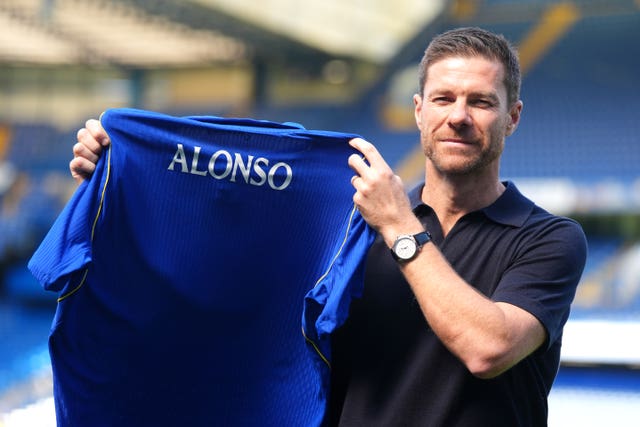 New Chelsea manager Xabi Alonso poses for photographs holding a Chelsea shirt