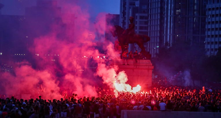 Liverpool fans let off flares outside the Liver Building