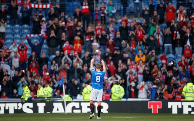 Steven Gerrard applauds the travelling supporters after playing for both teams during a Rangers v Liverpool legends match at Ibrox