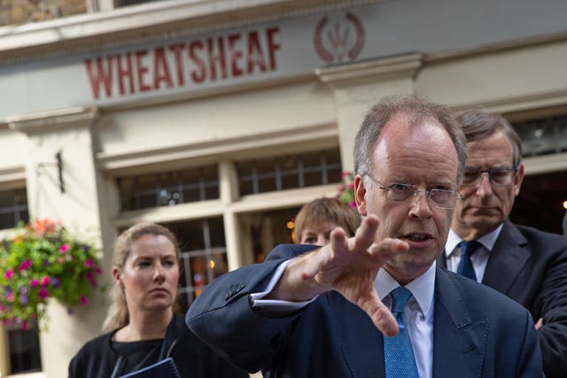 Chief Coroner Mark Lucraft QC (right) outside the Wheatsheaf where a member of the public was hit by a stray bullet (Aaron Chown/PA)