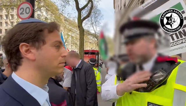 A screengrab of Gideon Falter speaking to the officer during march (Campaign Against Antisemitism/PA) 
