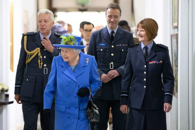 The Queen walks through the RAF Club