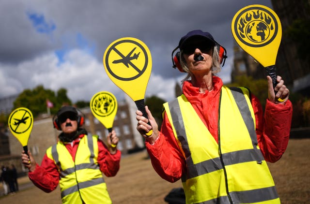 Campaigners protest against the expansion of UK airports, including the third runway at Heathrow, outside the Houses of Parliament