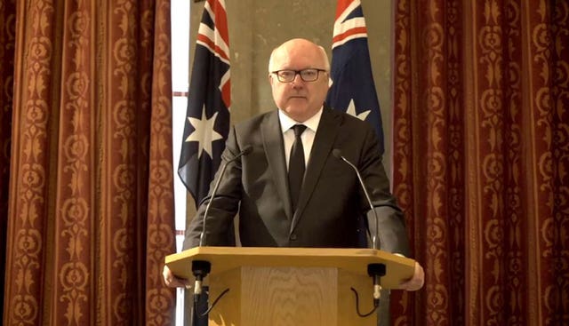 George Brandis speaking at a lectern