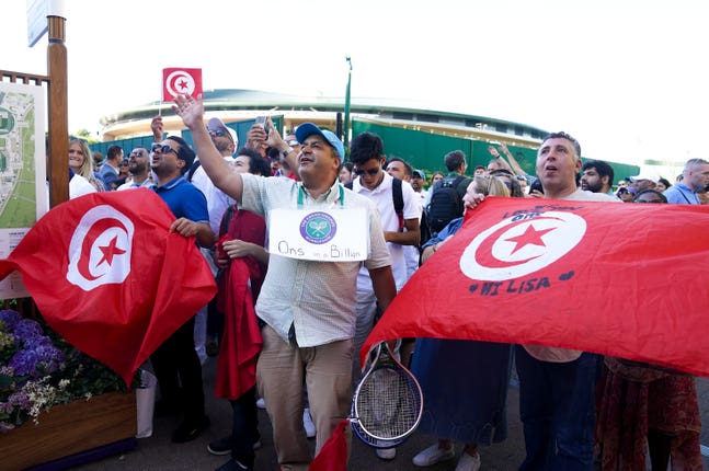 Ons Jabeur supporters show their support to the beaten finalist