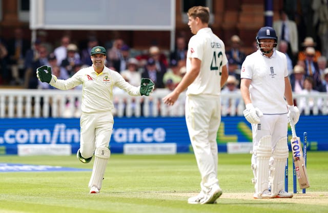 Alex Carey (left) celebrates his divisive stumping of Jonny Bairstow.