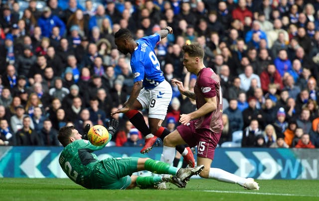 Jermain Defoe, centre, sees his shot blocked by St Johnstone's Cameron Bell